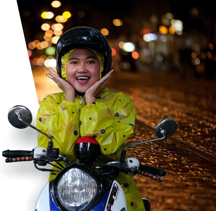Women driving motorcycle with ibex rain coat